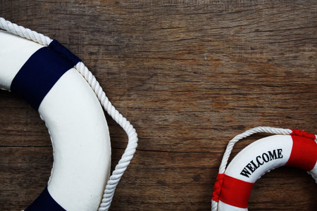 Nautical Lifebuoy with spac copy on wooden background