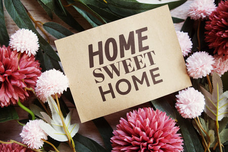 Home Sweet Home text message with flower decoration on wooden backgroundの写真素材