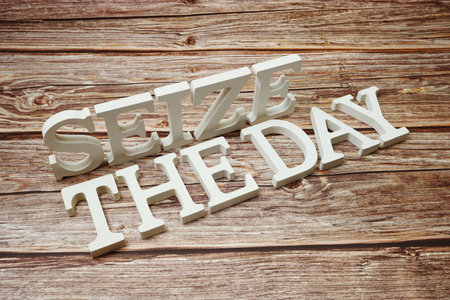 Seize The Day alphabet letters on wooden backgroundの写真素材