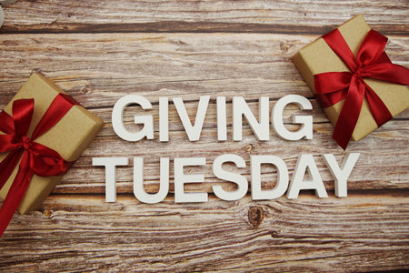 Giving Tuesday alphabet letters and gift box on wooden backgroundの写真素材