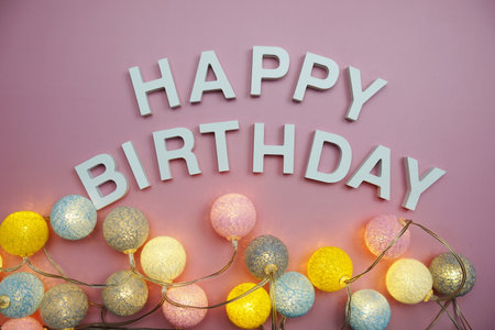 Happy Birthday alphabet letters on pink backgroundの写真素材