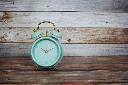 Alarm clock on wooden backgroundの写真素材