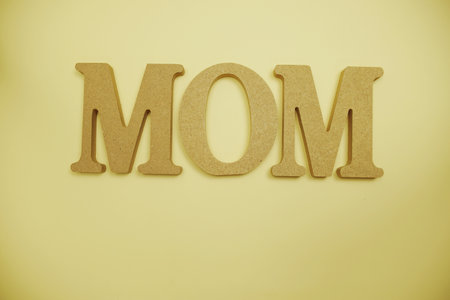Mother's day theme with MOM letters on yellow backgroundの写真素材