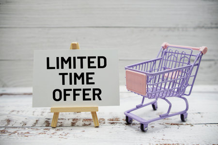Limited Time Offer text message and trolley shopping cart on wooden backgroundの写真素材