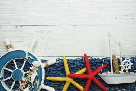 Nautical ornaments Antique sail boat Toy model and lifebuoy on wooden backgroundの写真素材