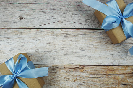 Gift boxes with blue ribbon on wooden backgroundの写真素材