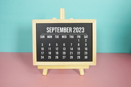 September 2023 monthly calendar on easel stand on pink and blue backgroundの写真素材