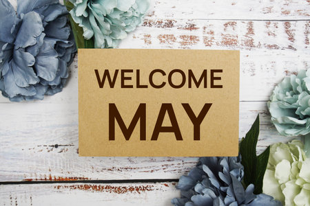 Welcome May text message with flower decoration on wooden backgroundの写真素材