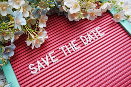 Save the Date text on Letter Board with flower decorationの写真素材