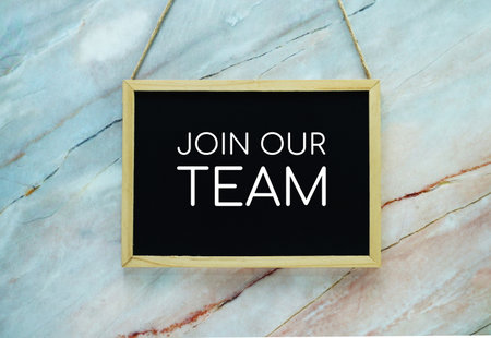 Join Our Team typography text on wooden blackboard hanging on marble backgroundの写真素材