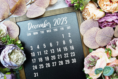 December 2023 monthly calendar with flower bouquet decoration on marble background