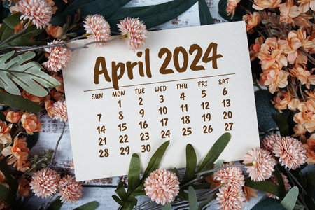 April 2024 monthly calendar with flower bouquet decoration  on wooden backgroundの写真素材