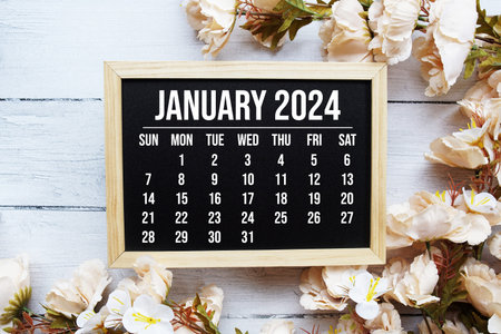 January 2024 monthly calendar with flower bouquet decoration on wooden background