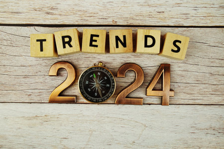 Trends of 2024 alphabet letters with magnifying glass on wooden backgroundの写真素材