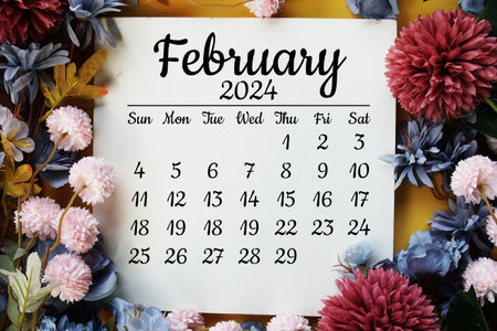 February 2024 monthly calendar with flower bouquet decoration  on yellow backgroundの写真素材