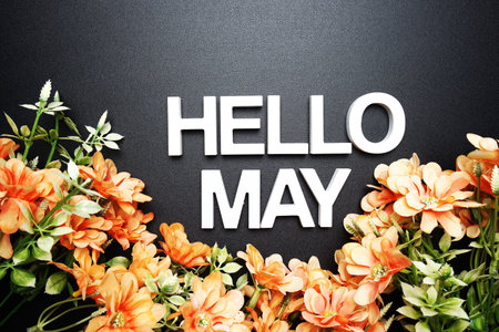 Hello May alphabet letter with flower decoration on black backgroundの写真素材
