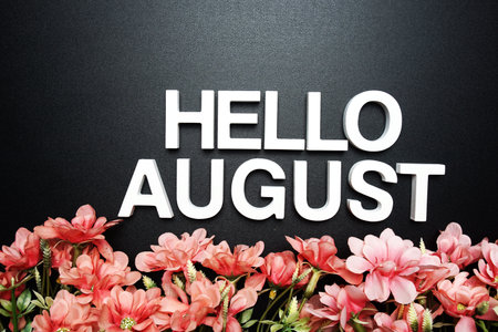 Hello August alphabet letter with flower decoration on black backgroundの写真素材