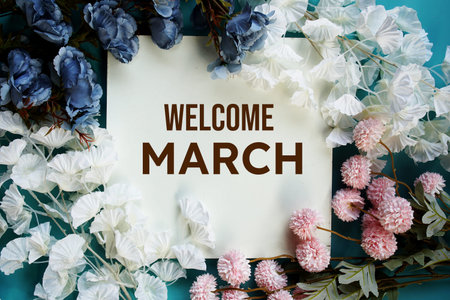 Welcome March text message with flower decoration on wooden background