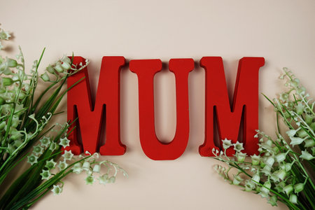 Happy Mother's day theme with MOM letters and flowers decoration on pink backgroundの写真素材