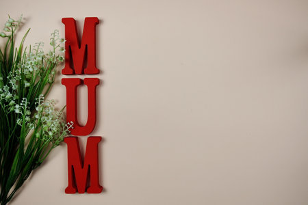 Happy Mother's day theme with MOM letters and flowers decoration on pink backgroundの写真素材