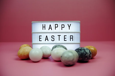 Happy Easter light box with easter element decoration on pink backgroundの写真素材