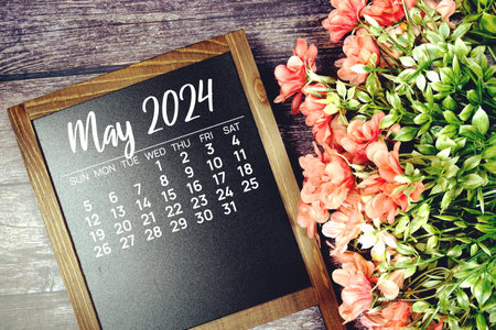 May 2024 monthly calendar with flower bouquet decoration on wooden backgroundの写真素材