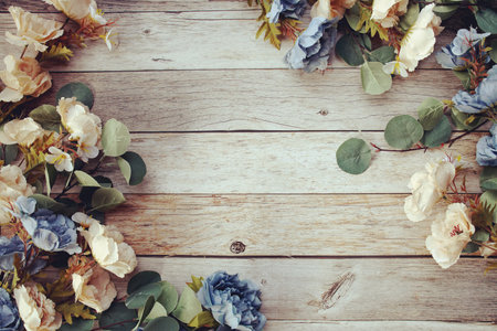 Beautiful pink flowers decoration with space for text message flat lay on wooden backgroundの写真素材