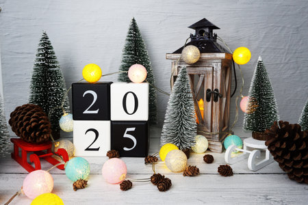 Happy New Year 2025 alphabet letters with Christmas tree decoration on wooden background