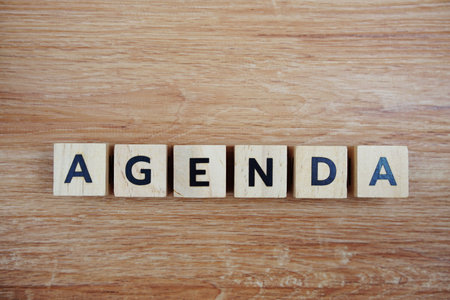 Agenda alphabet letters top view on wooden background, business conceptの写真素材