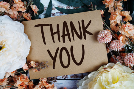 Thank You typography text with flower decorated on wooden backgroundの写真素材