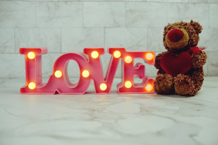 Pink Love LED Decorative and teddy bear with red heart on marble backgroundの写真素材