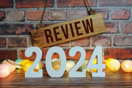 Review 2024 letters with LED cotton balls decoration on wooden backgroundの写真素材
