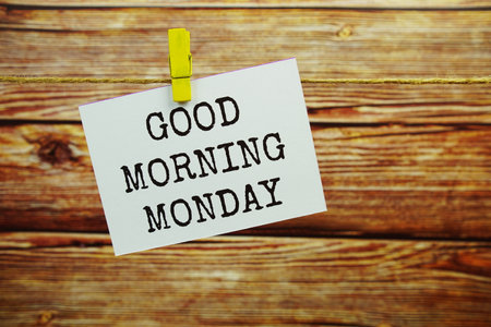 Good Morning Monday text on paper card hanging on the wall with Clothespinsの写真素材