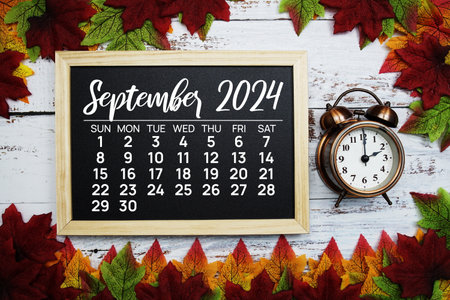 September 2024 monthly calendar maple leaf decoration on wooden backgroundの写真素材
