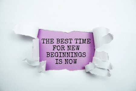 The Best Time For Nwe Beginnings Is Now message written on purple paper with torn paper backgroundの写真素材
