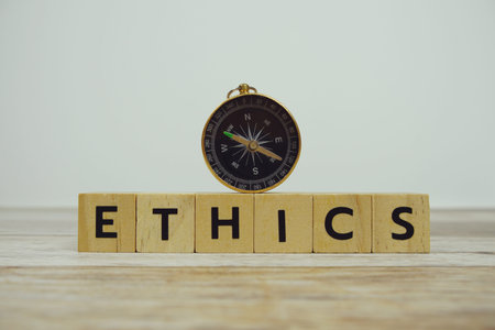 Compass with wooden blocks alphabet letters ETHICS on wooden backgroundの写真素材