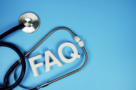 FAQ with wooden blocks alphabet letters and stethoscope on blue backgroundの写真素材