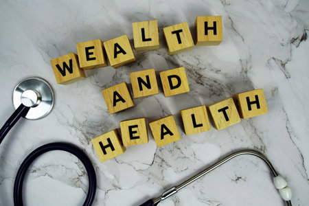 Wealth and Health with wooden blocks alphabet letters and stethoscope on marble backgroundの写真素材