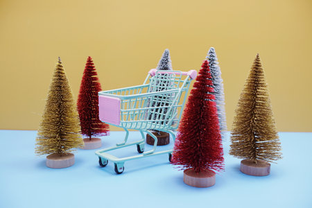 Christmas tree and trolley cart with space copy background. Christmas and New year sale conceptの写真素材