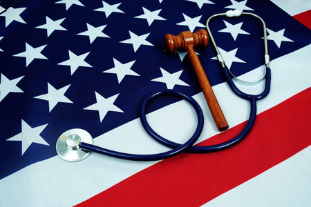 stethoscope medical equipment on usa flag health care conceptの写真素材