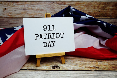911 Patriot Day text messege with USA flag on wooden background
