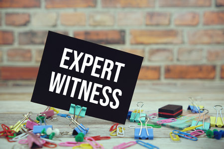 Expert Witness text on paper card with stationary on wooden backgroundの写真素材