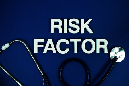 Risk Factor alphabet letters with stethoscope top view on blue background