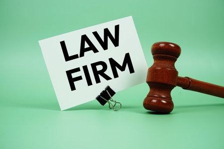 Law Firm text message with wooden judge gavel on green background