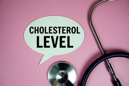 Cholesterol Level text message on speech bubble with Stethoscope  top view on pink background, Health concept backgroundの写真素材