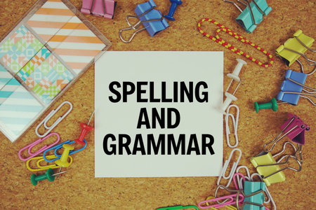 Spelling and Grammar text on paper card with stationery on cork board background