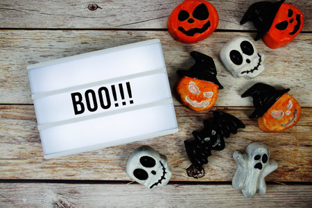 Halloween Concept with Boo!!! text in lightbox and Halloween Element decoration on wooden backgroundの写真素材