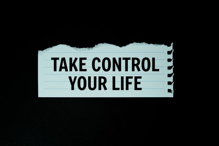 Take Control Of Your Life text on paper torn top view on black backgroundの写真素材