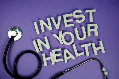 Invest in your health alphabet letters and stethoscope on purple background, Healthcare conceptの写真素材