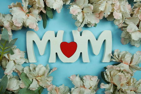Happy Mother's day theme with MOM letters and flowers decoration on blue backgroundの写真素材